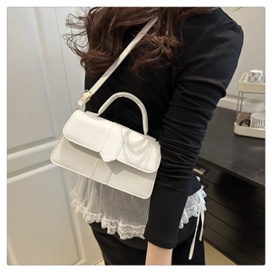 Detailed view of the white matte PU leather handbag with unique geometric flap and top handle