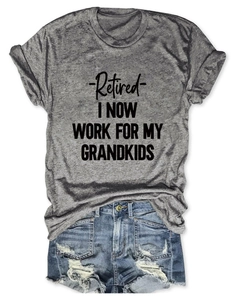 Flat lay of gray crew neck T-shirt with grandkids slogan and distressed blue denim shorts