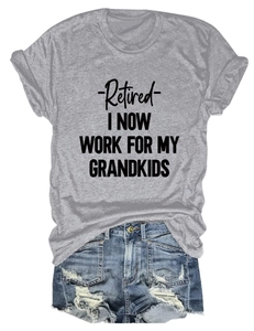 Flat lay of gray cotton t-shirt with 'Retired' text and distressed denim shorts