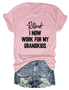Detail of pink cotton t-shirt with Retired Grandma slogan and ripped denim shorts