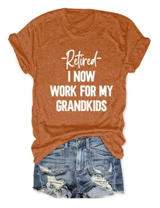 Flat lay of an orange letter print T-shirt paired with distressed denim shorts