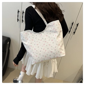 Rear view of a large white canvas tote bag with pink butterfly and tulip flower patterns