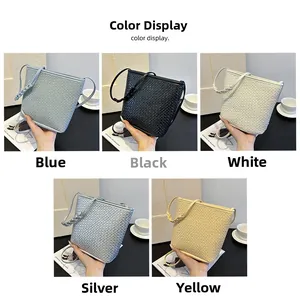 Detailed view of woven crossbody bucket bags in blue, black, white, silver, and yellow