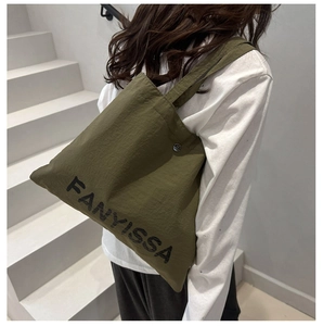 Detailed back view of an army green canvas tote bag with FANYISSA print and metal buckle