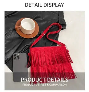 Close-up of red tassel crossbody bag with suede texture and gold metal hardware