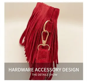 Macro shot of red suede fringe bag showing gold lobster clasp hardware and texture