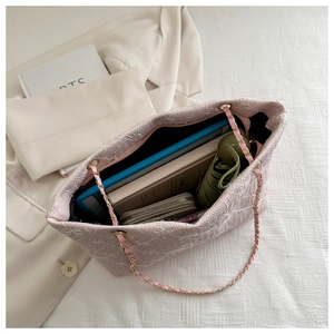 Detail view of pink floral embroidered tote bag showing spacious internal storage capacity