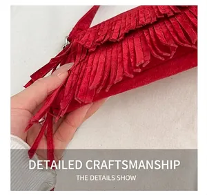 Detailed close-up of precise stitching and red matte suede texture on a tassel bag