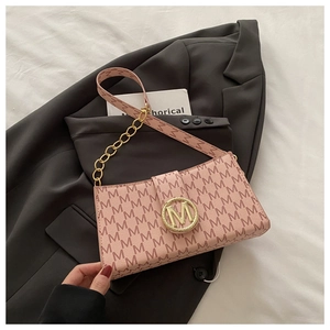 Detail of pink shoulder bag with M monogram print and golden metal circular clasp