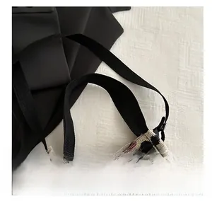 Detail of vintage floral canvas tote bag with reinforced black woven shoulder straps
