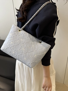 Chic light blue chain shoulder bag featuring floral embroidery and geometric patterns