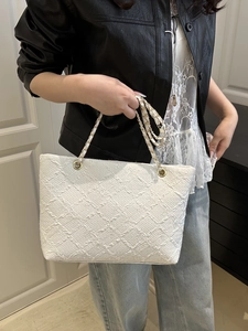 Elegant white textured tote bag with golden chain straps for summer fashion and commuting