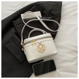 Mini borsa bianca in pelle con logo M dorato e doppia zip accanto a uno smartphone