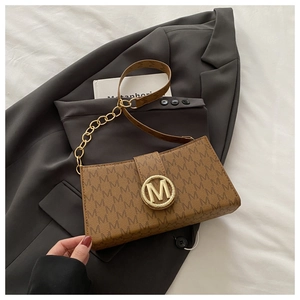 Detail of vintage brown monogram bag with golden M-shaped metal buckle and chain strap