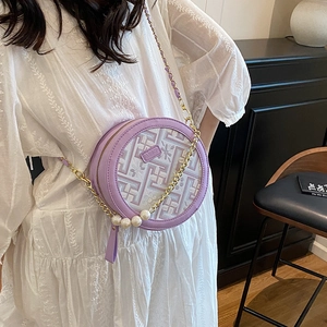 Lavender round crossbody bag with geometric texture, gold chain and pearl strap