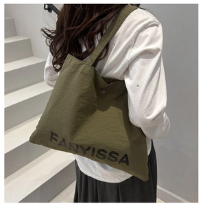 Army green nylon tote bag featuring black FANYISSA lettering and metal snap button