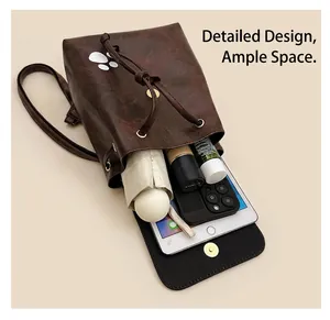 Detail view of brown PU leather backpack interior showing storage for tablet and umbrella