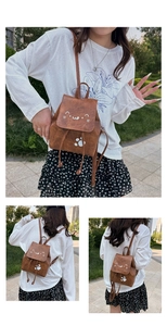 Detail of cute brown cartoon backpack with cat face print and drawstring closure