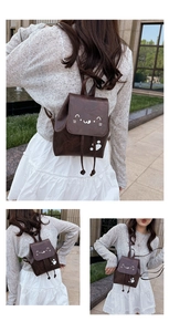 Detail of a dark brown mini cat-themed backpack featuring cat face and paw prints