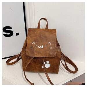 Detail of brown PU leather backpack featuring cute cat face print and cat paw pattern