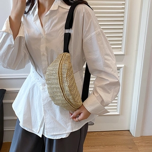 Trendy straw woven chest bag for women with black canvas strap and silver buckle detail