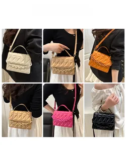 Quilted crossbody bag shown in various colors with chunky chain strap and crossbody style