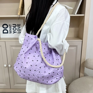 Purple textured shoulder tote bag with black bow patterns and cotton rope handle