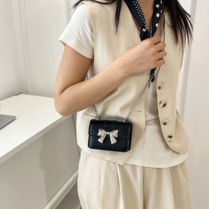 Mini black PU leather crossbody bag with silver bow accent and slim chain strap