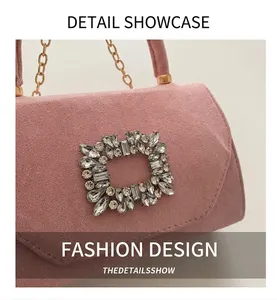 Close-up of pink velvet handbag with sparkling crystal buckle and gold chain strap