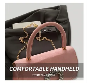 Pink faux suede handbag with rhinestone heart buckle and gold chain strap detail
