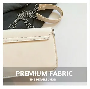 Close-up of the cream box bag back pocket and silver chain leather shoulder strap