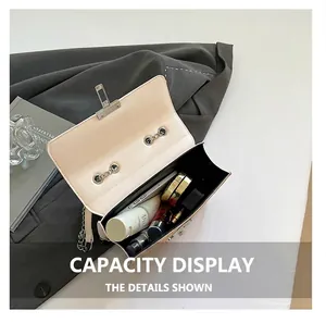 Detail view of the cream chain crossbody bag interior showing daily essentials storage