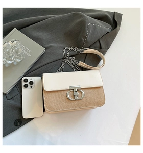 Detail showing woven texture contrast and T-shaped metal clasp with phone for size reference