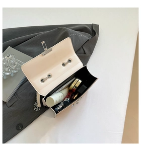 Detail of beige flap chain bag showing interior capacity for phone and cosmetics