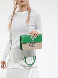 Green leather and woven patchwork shoulder bag with silver chain strap on model
