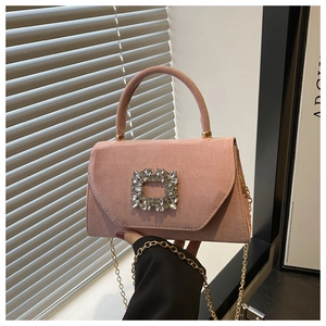 Detailed close-up of pink suede crossbody bag featuring a large square crystal buckle