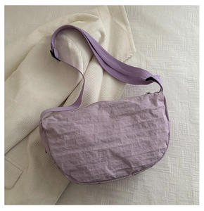 Top view of lavender nylon crescent bag with ruched texture and adjustable wide strap
