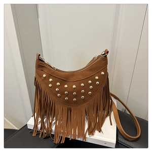 Détail de sac hobo en daim marron avec rivets dorés et longues franges élégantes