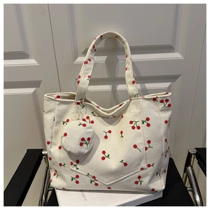 Detail of off-white corduroy tote bag with cherry pattern and matching small coin purse
