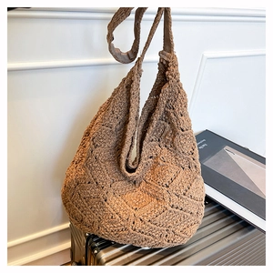 Macro shot of brown hand-crocheted hobo tote with detailed diamond weave pattern