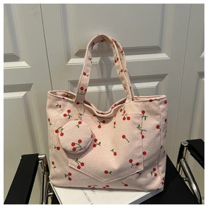 Detail of pink corduroy tote bag with red cherry prints and matching round coin purse