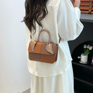 Brown patchwork crossbody bag with woven texture and silk scarf wrapped handle
