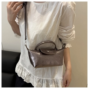 Detail of silver dumplings phone bag with metallic texture and adjustable strap