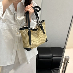 Summer woven straw tote bag with black leather trim and silver buckle strap