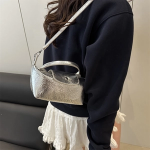 Metallic silver pleated crossbody bag with pearl handle and detachable shoulder strap
