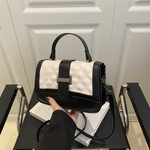 Sac à bandoulière noir et blanc à carreaux avec boucle argentée et poignée sur le haut