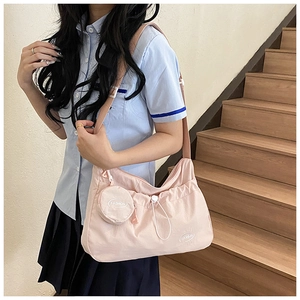 Detail of light pink waterproof nylon crossbody bag with fashion drawstring and mini pouch