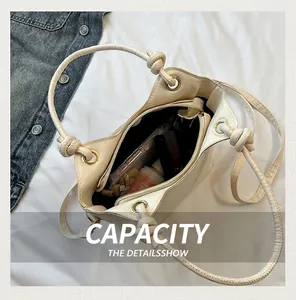 Top view of beige bucket bag interior showing spacious capacity for phone and cosmetics