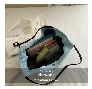 Detail view of large capacity denim tote bag interior showing storage for daily items