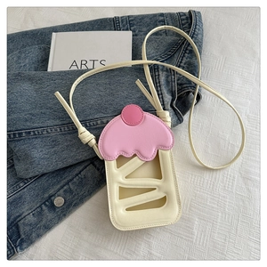 Detail of cute cupcake-shaped crossbody bag with hollow patterns and pink cream top
